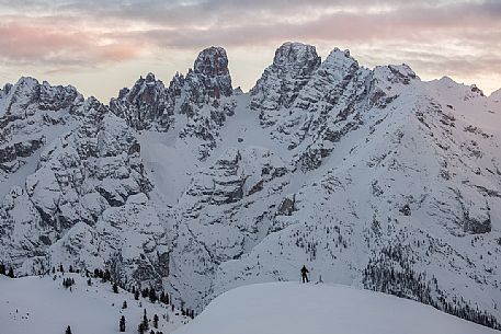 Trekker with snowshoes at sunset,looking the Piz Popena and Cristallo Mount form Prato Piazza, Braies, Trentino Alto Adige, Italy, Europe