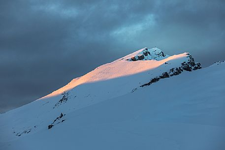 Last light of sunset over the summit cross of Picco di Vallandro mount, Prato Piazza, Braies, Trentino Alto Adige, Italy, Europe