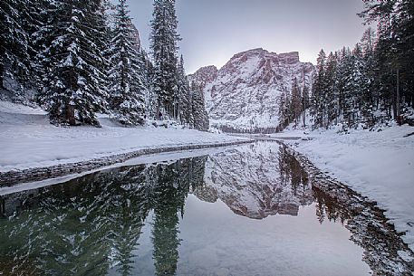 The Croda del Becco peak reflected on the almost frozen lake of Braies, Braies, Pusteria valley, Trentino Alto Adige, Italy, Europe