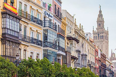 Palaces with typical wrought-iron terraces, on background appears the Giralda tower, Seville, Andalusia, Spain, Europe 