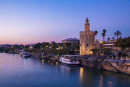 The Guadalquivir river dominated by one of the most famous monuments of Seville, the Moorish Torre del Oro, Seville, Andalusia, Spain, Europe
