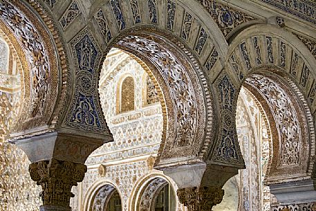 Decorated arches with Azulejos and complicated stuccos in the Hall of Ambassadors of the Real Alcazar building, Seville, Andalusia, Spain, Europe
