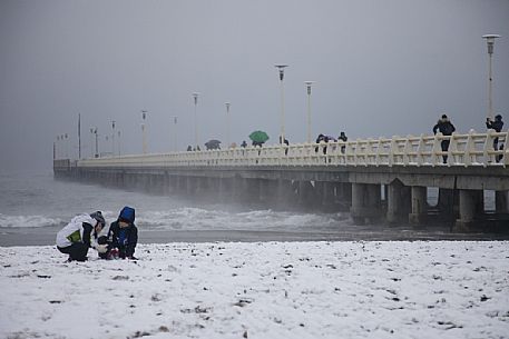 Children playing in the snowy Forte dei Marmi beach, Versilia, Tuscany, Italy, Europe Children playing in the snowy Forte dei Marmi beach, Versilia, Tuscany, Italy, Europe