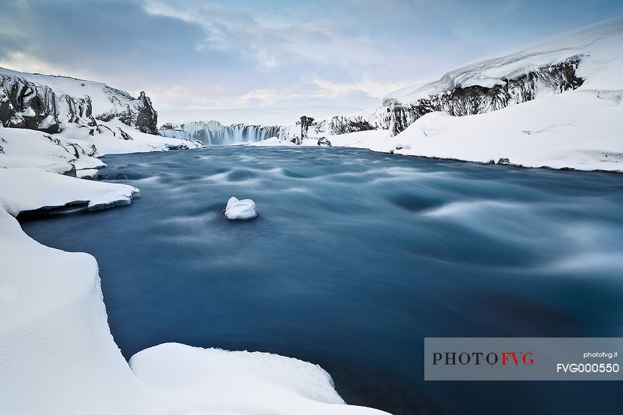 Godafoss waterfalls captured from below, after an intense period of snowfalls.