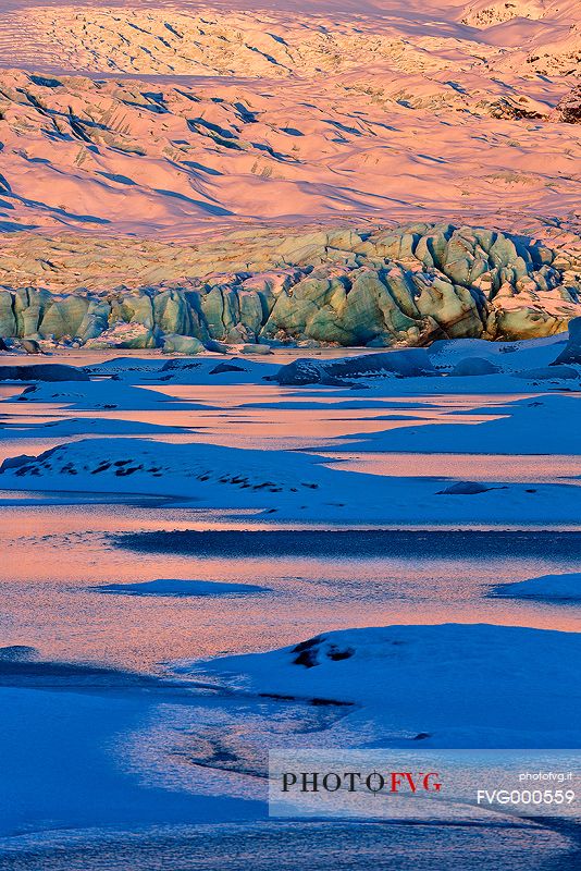 A detail of colourful Vatnajkull ice at the first light of sunrise.