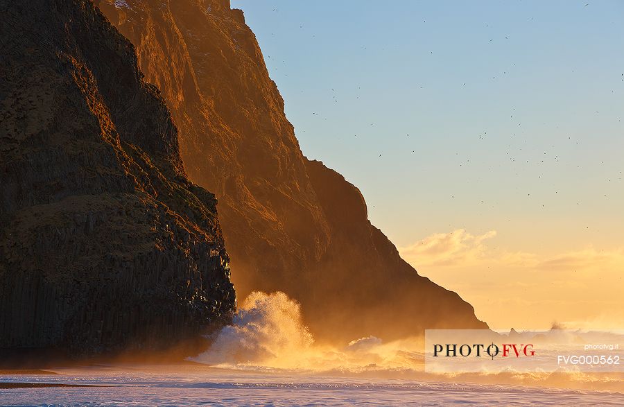 Intense light on the basaltic rocks at Vik, during a sunrise in January.