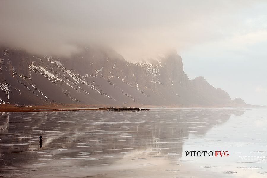 A risk lover photographer takes picture from the middle a frozen lagoon