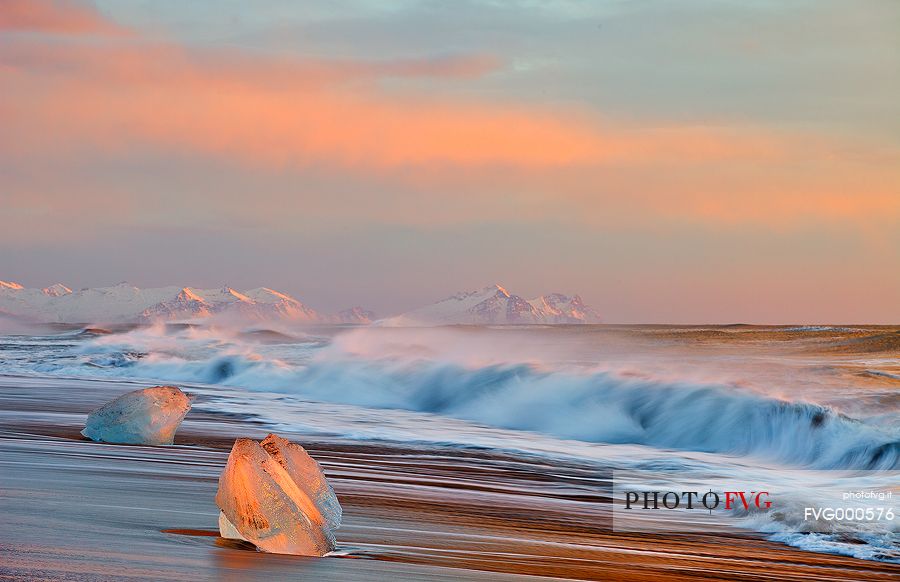 An intense sunrise displays amazing colours and light on the ice and waves