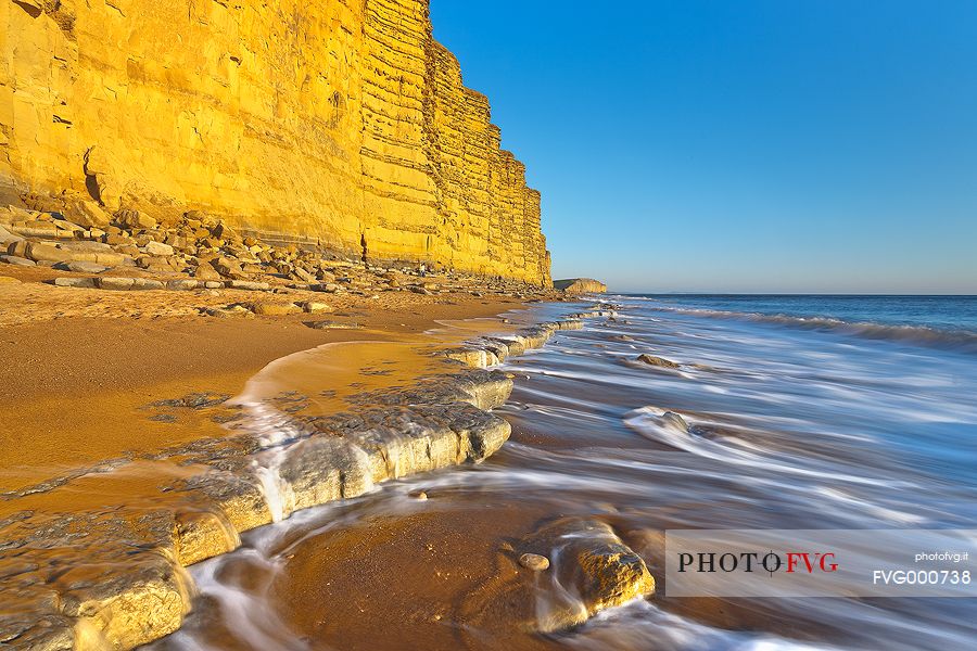 The golden cliffs of Burton Bradstock just before the sunset