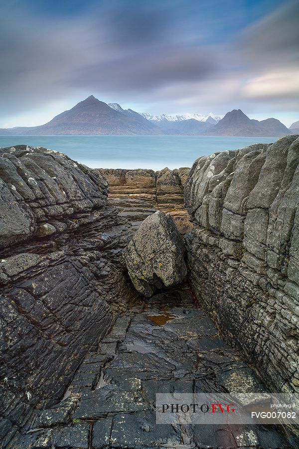 The Cuillin Hills view from Elgol Beach is simply amazing. Thanks to the long time exposure this picture shows the contrast between the static rocks and the dynamic sky on the background