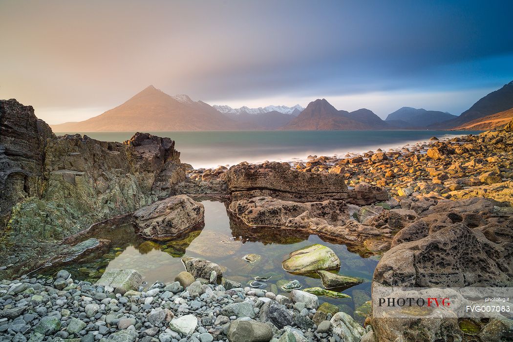 The Cuillin Hills view from Elgol Beach is simply amazing. Thanks to the long time exposure this picture shows the contrast between the static rocks and the dynamic sky on the background