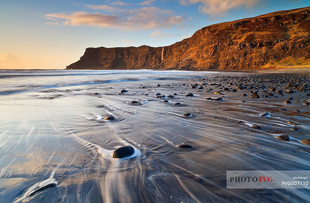 Last light in the afternoon hits the North cliffs of Talisker Bay