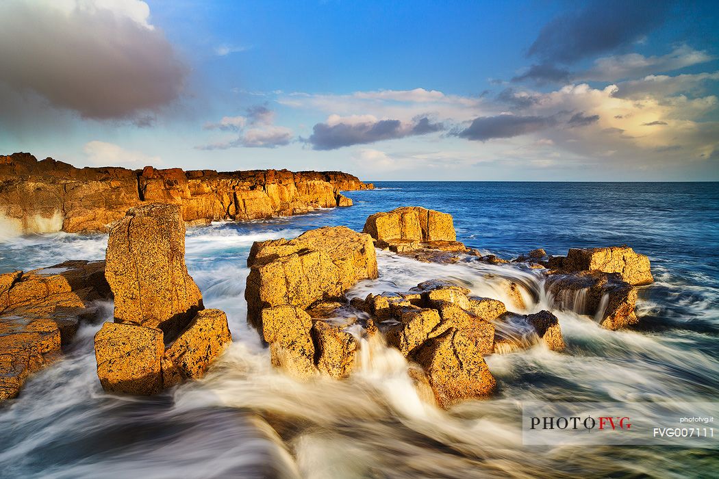 Contrast between the yellow rocks and the blue water at Staffin Bay