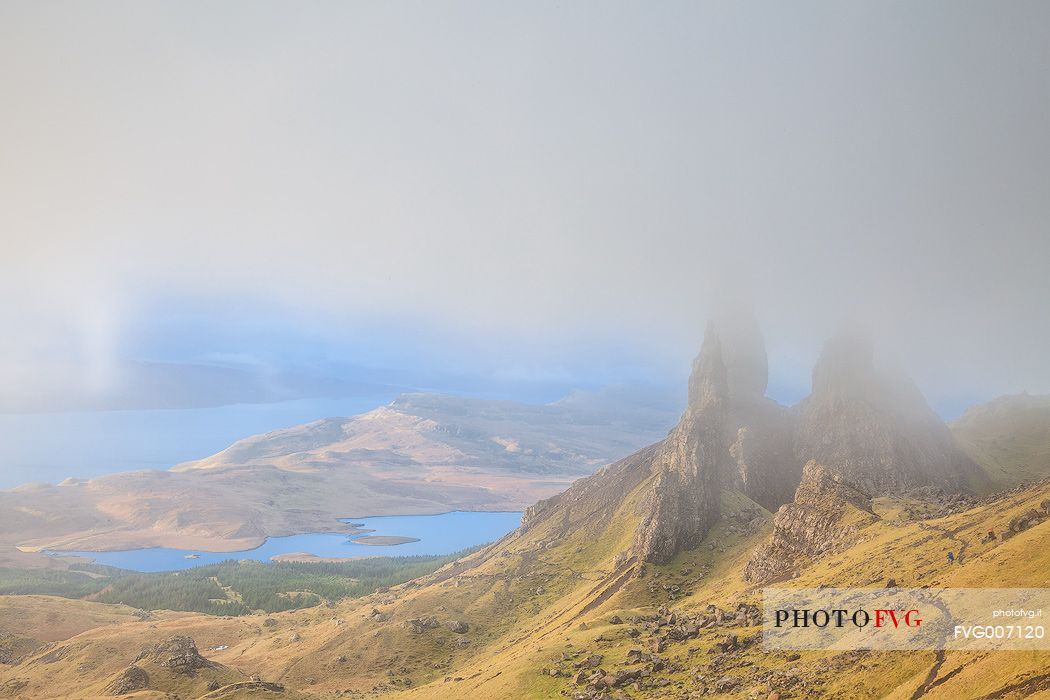 The clouds embraced the famous pinnacle of Old Man of Storr during a misty morning