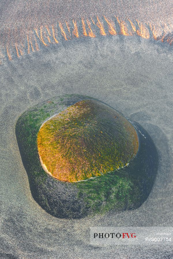 A green stone shows up during the low tide at Talisker Bay