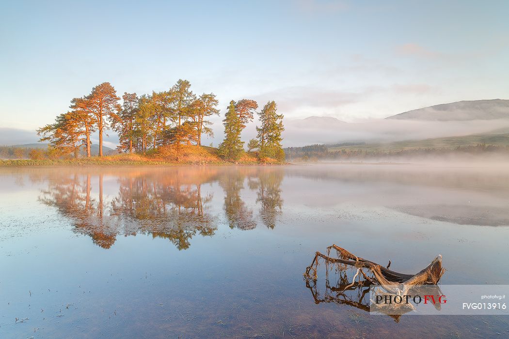 First light in the morning hits the isle on the lake for a beautiful view