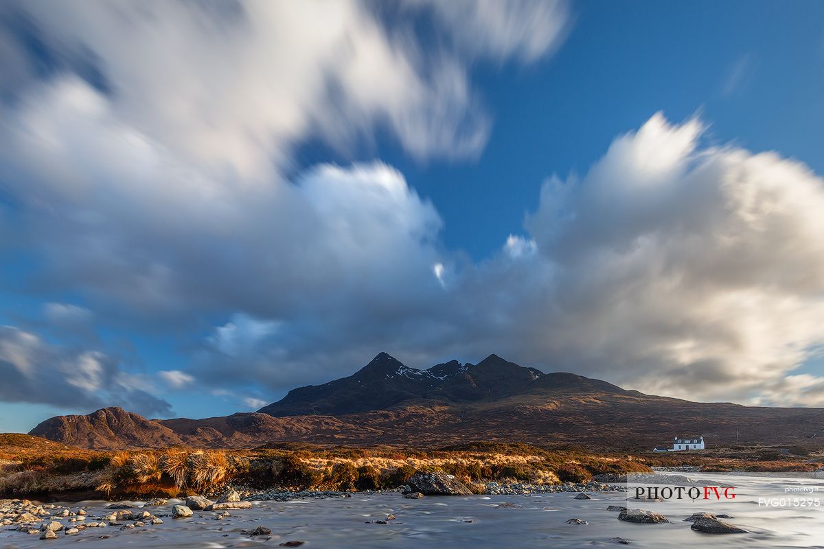 The late afternoon light embraces the landscape and a little cottage at sligachan, admiring the Cuillins on the background