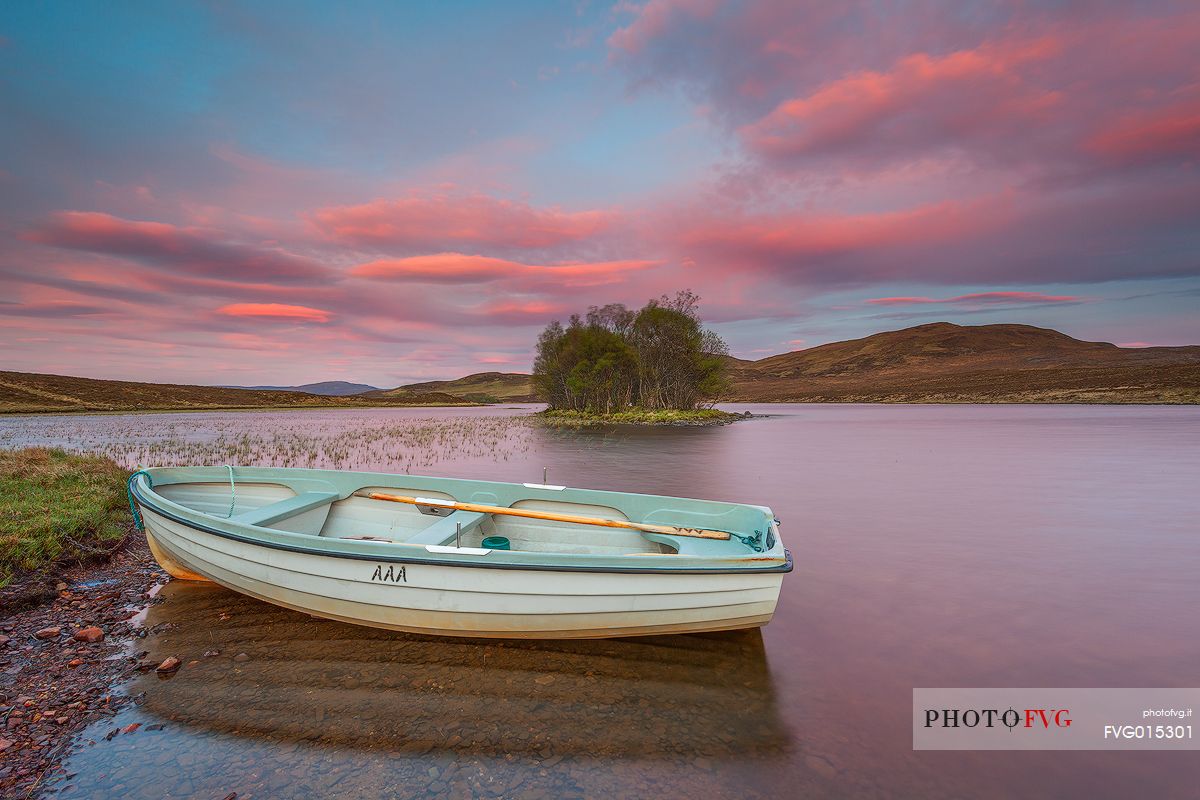 The fishermans boats anchored on the shore of the fascinating Loch Assynt