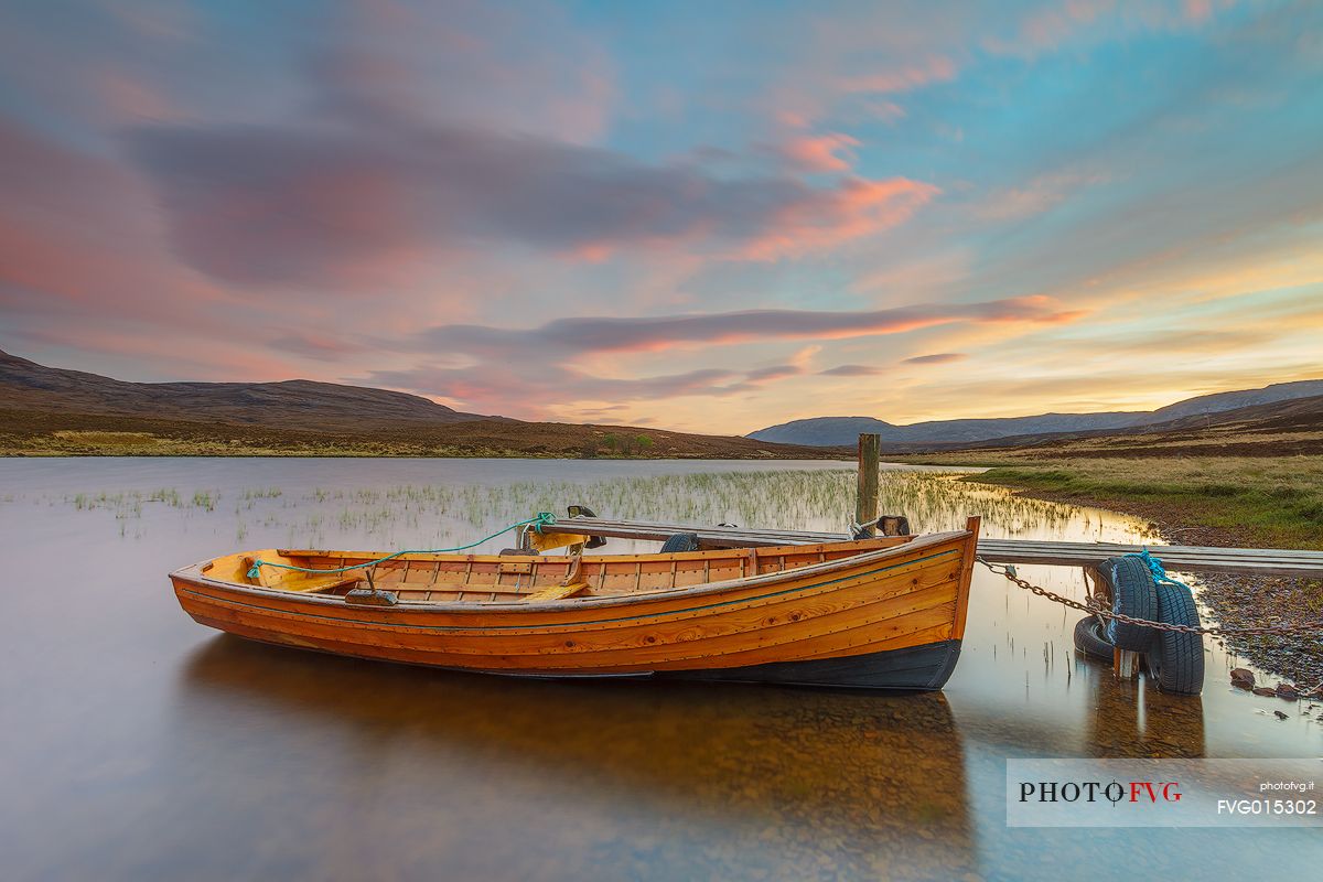 The fishermans boats anchored on the shore of the fascinating Loch Assynt