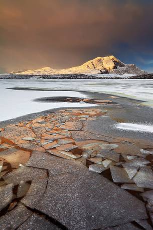 Frozen lake up north, snow storm on top the mountains and first light in the morning; that's the real scottish Winter