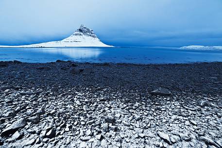 A frozen sunrise at Kirkjufell, the pyramidal mountain in the West of Iceland.