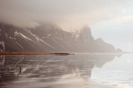 A risk lover photographer takes picture from the middle a frozen lagoon