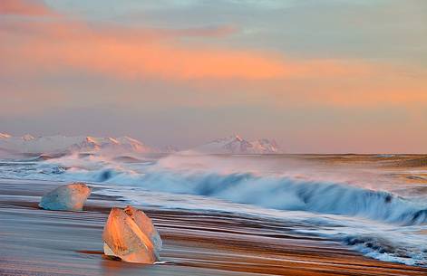 An intense sunrise displays amazing colours and light on the ice and waves