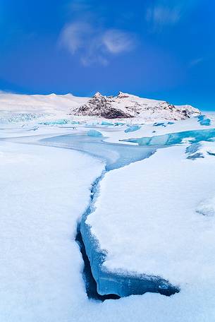 A frozen small lagoon near by Jokulsarlon admired during a fine sunrise