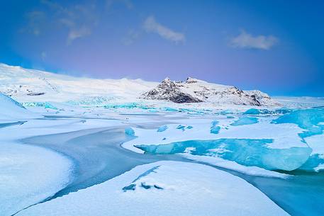A frozen small lagoon near by Jokulsarlon admired during a fine sunrise