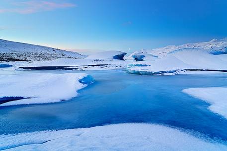 A frozen small lagoon near by Jokulsarlon admired during a fine sunrise