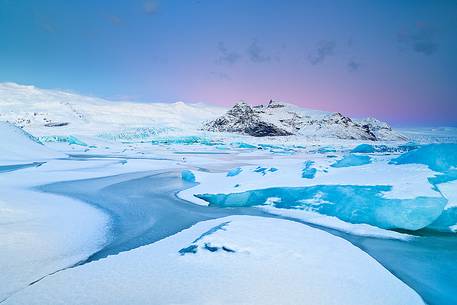 A frozen small lagoon near by Jokulsarlon admired during a fine sunrise A frozen small lagoon near by Jokulsarlon admired during a fine sunrise