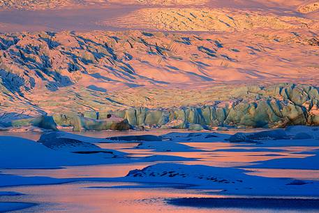 A detail of colourful Vatnajkull ice at the first light of sunrise.
