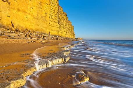 The golden cliffs of Burton Bradstock just before the sunset