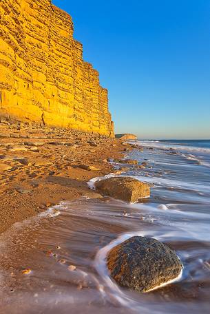 The golden cliffs of Burton Bradstock just before the sunset