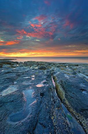 Sunset on the rocks of Bamburgh