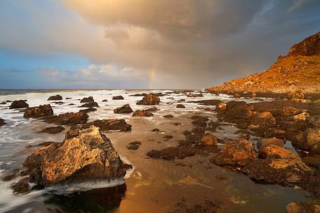 Last Light and a shy rainbow enriches the landscape at Singing sands