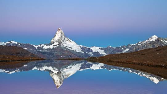 The Summit of the Matterhorn reflected in Stellisee during a relaxing sunrise