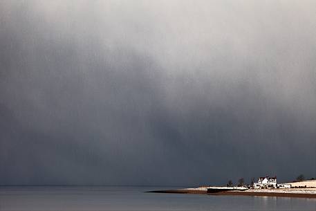 This one looks like the OZ empire. a storm was coming and left alone a white house. 