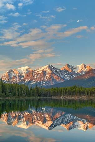 Moon is reflected at Herbert Lake during a colorful sunrise