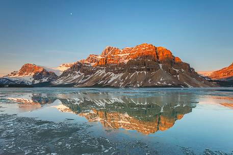 The moon above Bow lake at sunrise