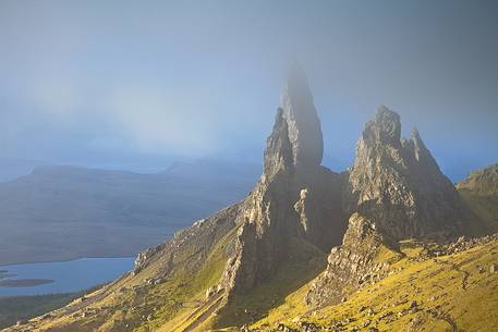 The clouds embraced the famous pinnacle of Old Man of Storr during a misty morning