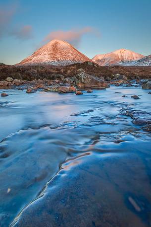 The warm light of the sunset hits the Red Cuillin