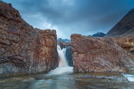 One of the beautiful waterfalls at fairy pools is illuminated by the last light in the afternoon, United Kingdom, UK, Scotland, Inner Hebrides , Isle of Skye One of the beautiful waterfalls at fairy pools is illuminated by the last light in the afternoon, United Kingdom, UK, Scotland, Inner Hebrides , Isle of Skye