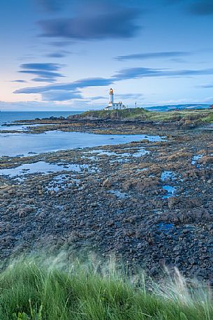 The view of the lighthouse from above during a windy day. This picture has been taken few minutes after the sunset The view of the lighthouse from above during a windy day. This picture has been taken few minutes after the sunset