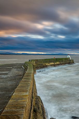 The wind and waves at Burghead Harbor during the sunset