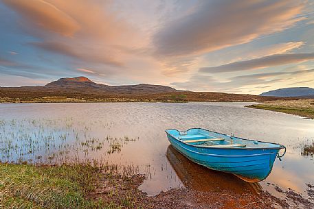 The fishermans boats anchored on the shore of the fascinating Loch Assynt