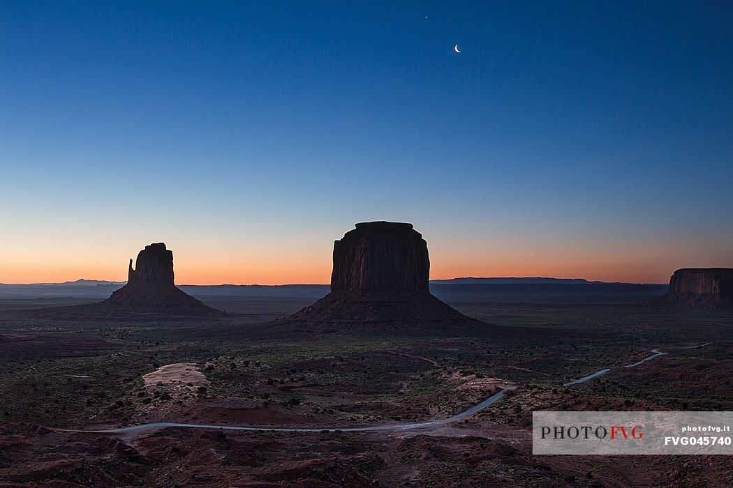 Scenic view of the first light of the dawn on the background of The Mittens and Merrick Butte  from John Wayne's Point the Oljato Navajo Monument Valley, Arizona USA 