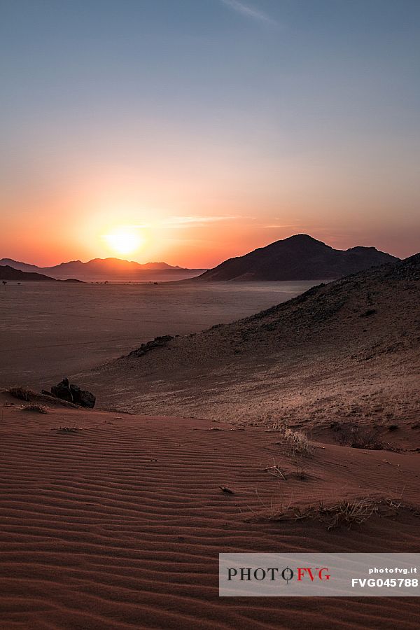 Sunset from the Tiras Mountains with scenic view on the valley below in Kanaan Desert Retreat, border of Namib Desert, Namibia, Africa