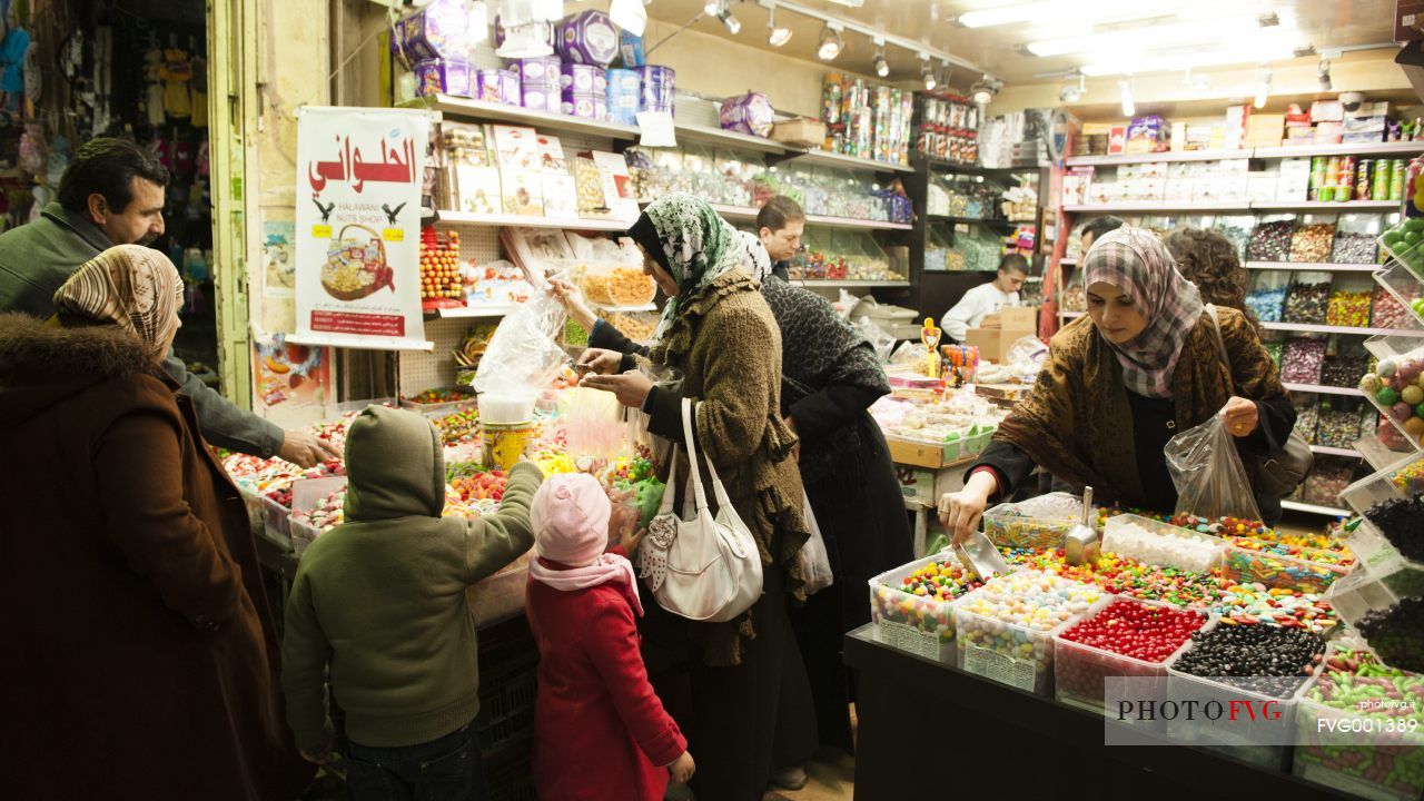 People buying candy in the small streets of Old Jerusalem, Israel