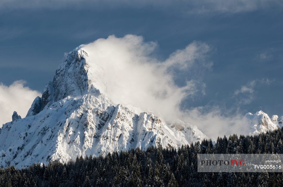 Clouds come off the mountain Sernio after a snowfall 